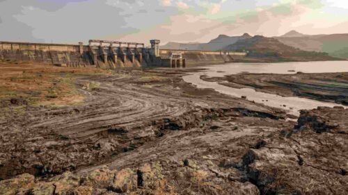 Aerial view of Khadakwasla Dam in Pune showing low water levels and silt accumulation affecting storage capacity.