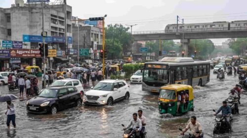 Vehicles navigating through heavily waterlogged streets in Delhi-NCR during heavy monsoon downpours.