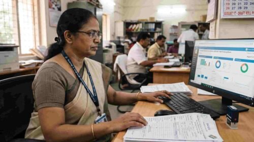 emale Election Officer digitizing voter enumeration forms for Telangana Special Intensive Revision 2026.