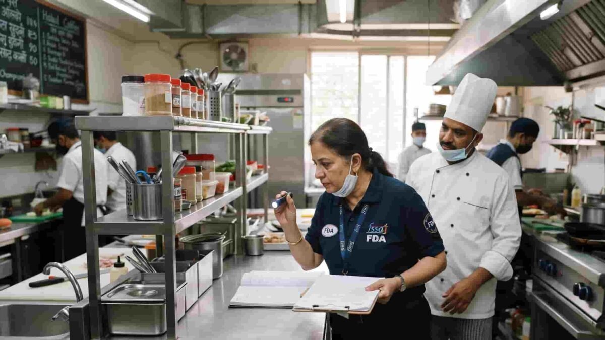 Food and Drug Administration officers conducting safety and hygiene inspections at a restaurant in Pune.
